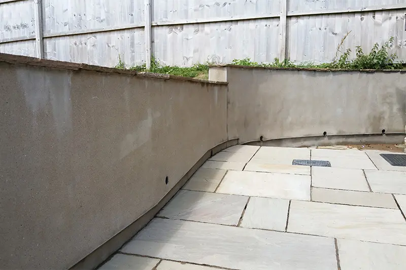 Rendered wall and patio after cleaning — clean surface restored