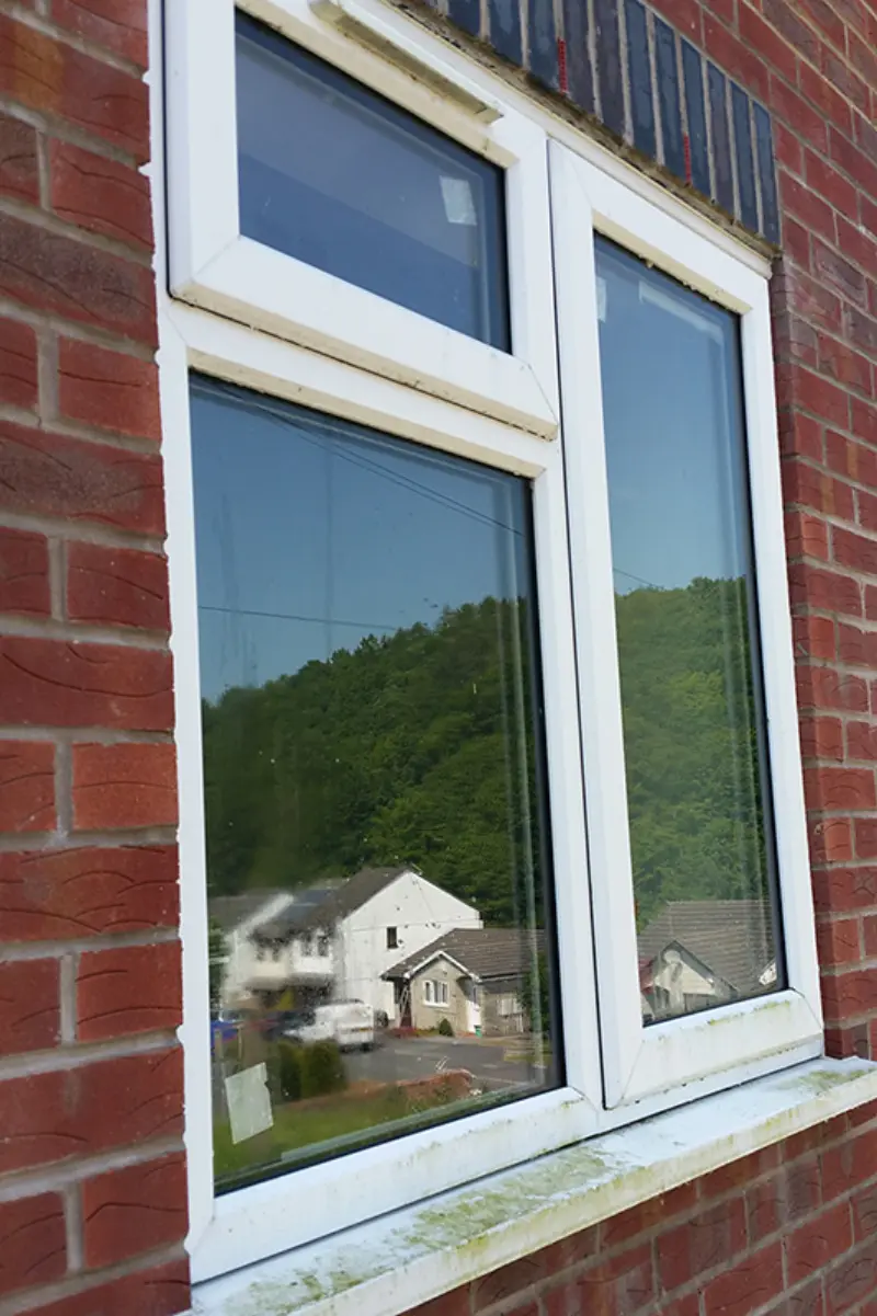 Window before cleaning — visible grime on glass and sill